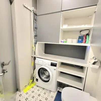 a laundry room with a washer and dryer at HaPPy Inn Laime Studio, Self Check-In-24-7, A-C, Parking-in-the-underground-Garage in Vilnius