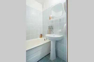 a bathroom with a sink and a bath tub and a sink at Cozy private room in a three room apartment Free parking Feel like at home in Vilnius