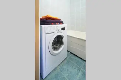 a washing machine in a bathroom next to a tub at Cozy private room in a three room apartment Free parking Feel like at home in Vilnius