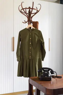a dress on a mannequin on a table with a telephone at Suite with private bathroom at three bedroom interwar Villa Grabyte with daily spaces to share by pine forest on the bank of the river- 8min by car from old town in Kaunas