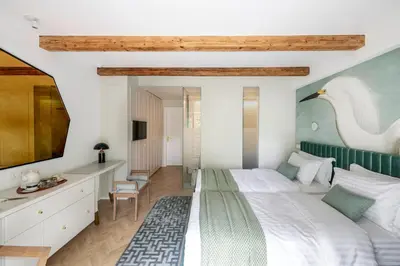 a bedroom with a large bed with a swan on the wall at Suite with private bathroom at three bedroom interwar Villa Grabyte with daily spaces to share by pine forest on the bank of the river- 8min by car from old town in Kaunas
