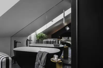 a bathroom with a black and white bath tub at Berman House in Kaunas