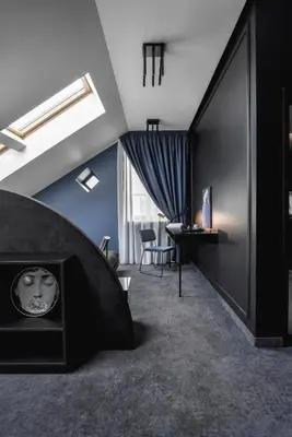a living room with a fireplace and a table at Berman House in Kaunas