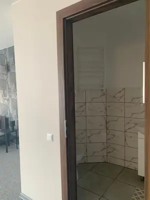 a door leading into a room with a wall of paper at Hotel Marijampole in Marijampolė