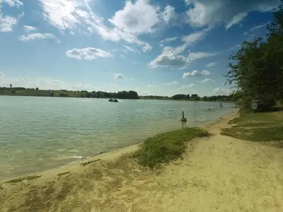a sandy beach next to a body of water at Gilužio Rivjera in Vilnius