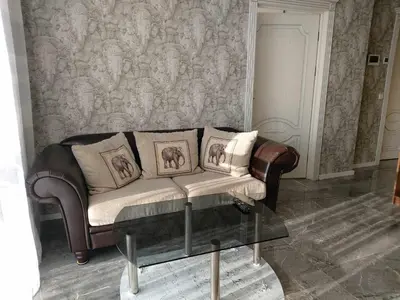 a living room with a couch and a table at Gilužio Rivjera in Vilnius
