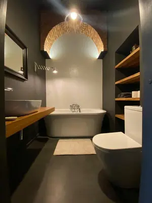 a bathroom with a tub and a toilet and a sink at Traukinių namai #1 in Švenčionėliai