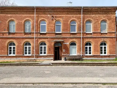 a brick building with a door in the middle at Traukinių namai #1 in Švenčionėliai