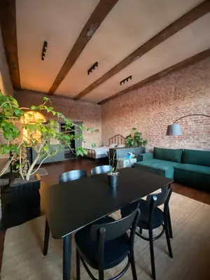 a living room with a table and a couch at Traukinių namai #1 in Švenčionėliai