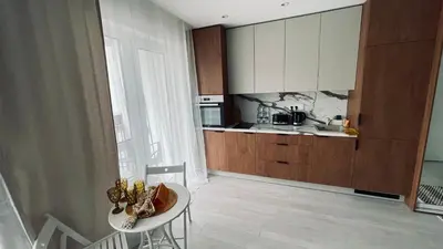 a small kitchen with a table and a counter at Ozo flat in Vilnius