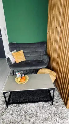 a living room with a table and a couch at Ozo flat in Vilnius