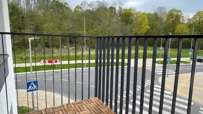 a view of a street from a balcony with a gate at Ozo flat in Vilnius