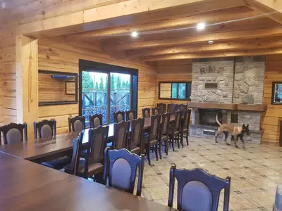 a conference room with a dog in the middle at Viesu vila Trakai ,su ežero pakrante in Meiluškės