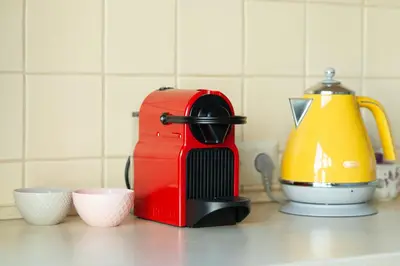 a red mixer sitting on a counter next to cups at Poilsis klonyje in Druskininkai