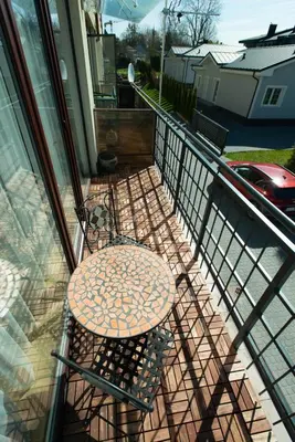 a table and chair sitting on a balcony at Poilsis klonyje in Druskininkai