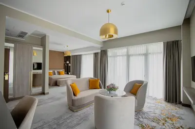 a living room with two couches and a living room with yellow pillows at Mineral SPA Draugystė in Druskininkai