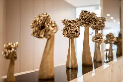 a group of gold vases on a table at Mineral SPA Draugystė in Druskininkai