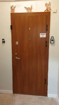 a wooden door in a wall with a sign on it at kauno street home in Vilnius