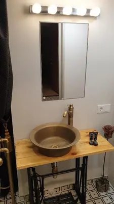 a bathroom sink with a mirror on a wooden table at kauno street home in Vilnius