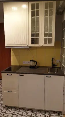 a kitchen with white cabinets and a sink at kauno street home in Vilnius
