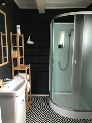 a bathroom with a shower and a sink at Atostogų namelis Laukys in Druskininkai