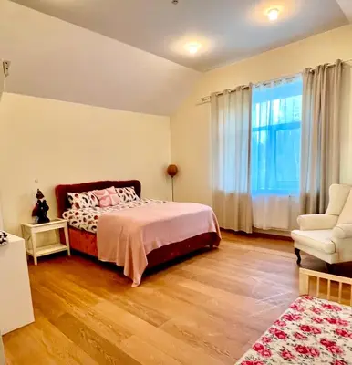 a bedroom with a bed and a chair and a window at Wonderful 8 Bedroom Home near Vilnius in Didžioji Reišė