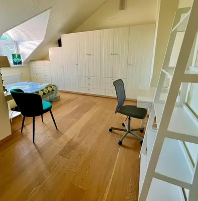 a room with two chairs and a desk and a bed at Wonderful 8 Bedroom Home near Vilnius in Didžioji Reišė