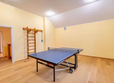 a ping pong table in the middle of a room at Wonderful 8 Bedroom Home near Vilnius in Didžioji Reišė