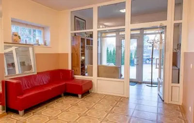 a living room with a red couch and glass doors at Wonderful 8 Bedroom Home near Vilnius in Didžioji Reišė