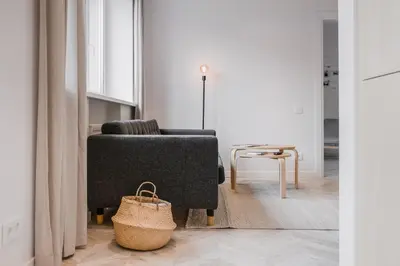 a living room with a couch and a chair at Central Apartment in Architectural Street in Kaunas