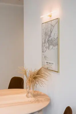 a table in a room with a picture on the wall at Central Apartment in Architectural Street in Kaunas