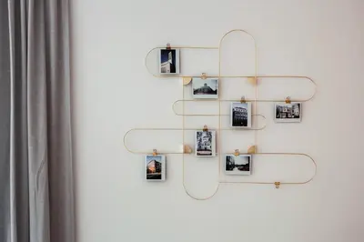 a group of photos hanging on a wall at Central Apartment in Architectural Street in Kaunas