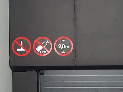 a sign on a wall withhibited signs on it at HaPPy Inn VIP, Self Check-In-24x7, A-C, Parking-in-the-underground-Garage in Vilnius
