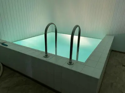 a bath tub with three bars in a bathroom at Svečių namai prie Širvintų in Akmeniai
