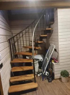 a set of stairs in a house with the sun shining at Nuomojama sodyba Rokiškio rajonas , Aukštakalnių kaimas ,Ežero gatvė 2 in Kuosiai