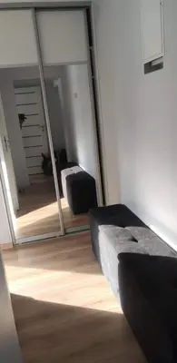 a room with a mirror and a couch and a bed at Butas miesto centre/ Apartment in the city center in Šiauliai