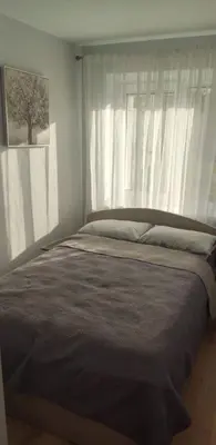 a bed in a bedroom with a window at Butas miesto centre/ Apartment in the city center in Šiauliai