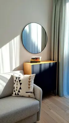 a mirror on a dresser in a room with a couch at Park Premium Apartments in Birštonas