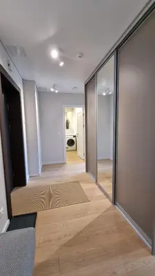 a hallway with sliding glass doors in a room at Park Premium Apartments in Birštonas