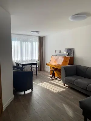 a living room with a couch and a piano at APARTMENTS IN THE CITY CENTER BIRŽAI Vytauto g22 in Biržai