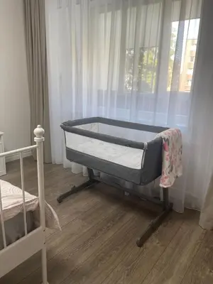 a bed sitting in a room with a window at APARTMENTS IN THE CITY CENTER BIRŽAI Vytauto g22 in Biržai