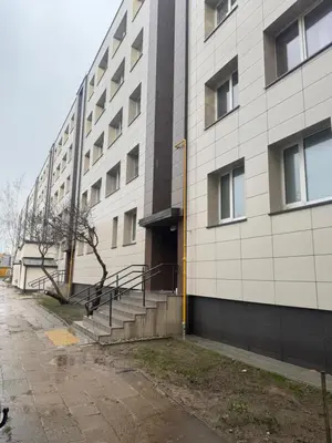 a large white building with a staircase next to it at APARTMENTS IN THE CITY CENTER BIRŽAI Vytauto g22 in Biržai