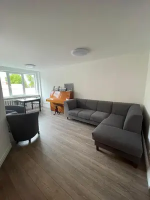 a living room with two couches and a piano at APARTMENTS IN THE CITY CENTER BIRŽAI Vytauto g22 in Biržai