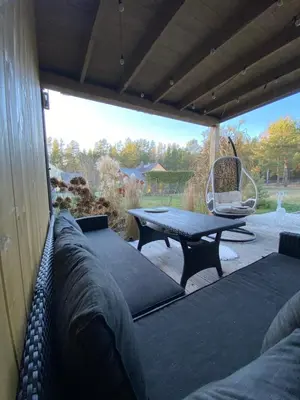 a patio with a bench and a table and a chair at Atostogų namas Twins in Druskininkai