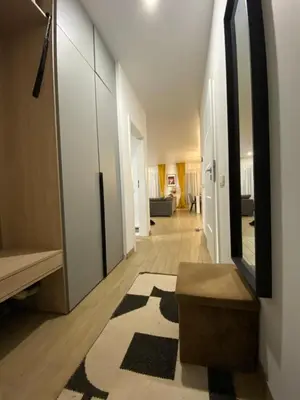 a hallway with a large mirror and a rug at Atostogų namas Twins in Druskininkai