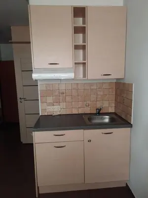 a kitchen with white cabinets and a sink at Cozy place in Žirmūnai 2 in Vilnius