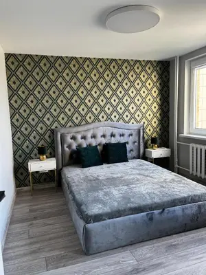 a bedroom with a large bed and two tables at 2-bedrooms apartment in city center Šiauliai in Šiauliai