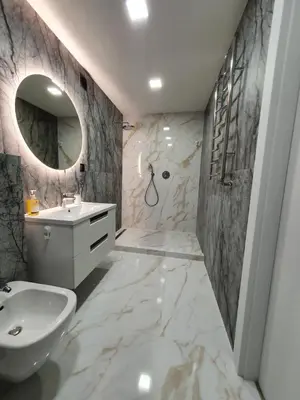 a bathroom with a sink and a toilet and a mirror at 2-bedrooms apartment in city center Šiauliai in Šiauliai
