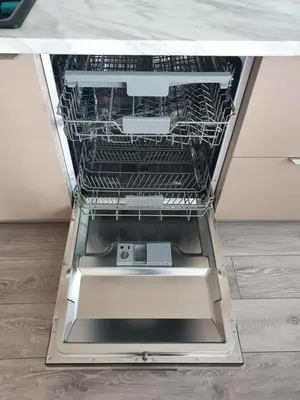an empty dishwasher with its door open in a kitchen at 2-bedrooms apartment in city center Šiauliai in Šiauliai
