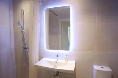 a bathroom with a sink and a shower with a mirror at VEPA in Vepriai